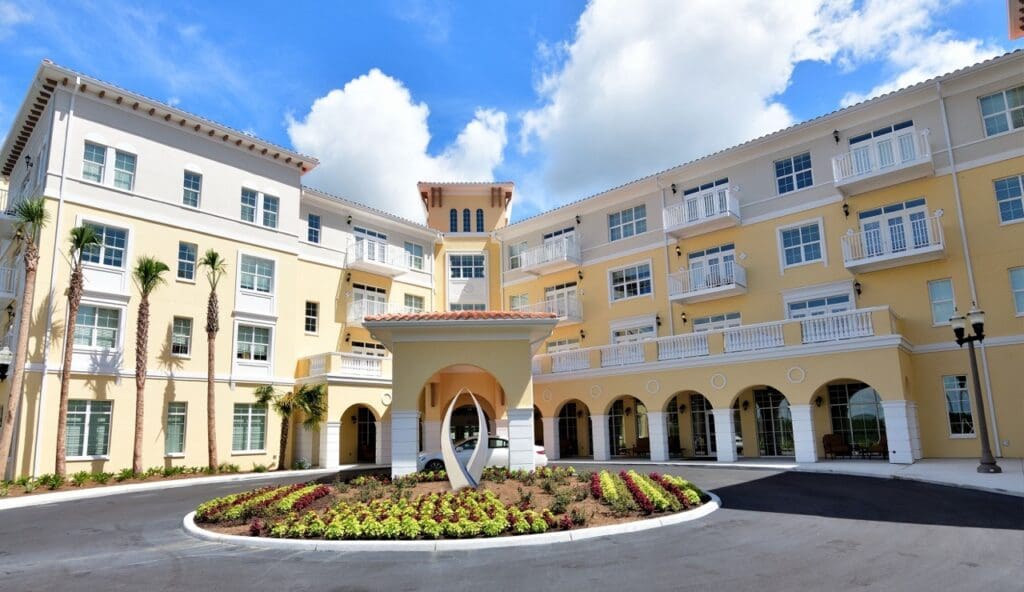 Exterior-Large-2 - Grace Management Elegant senior living community with vibrant landscaping and modern architecture, inviting residents to an upscale lifestyle.