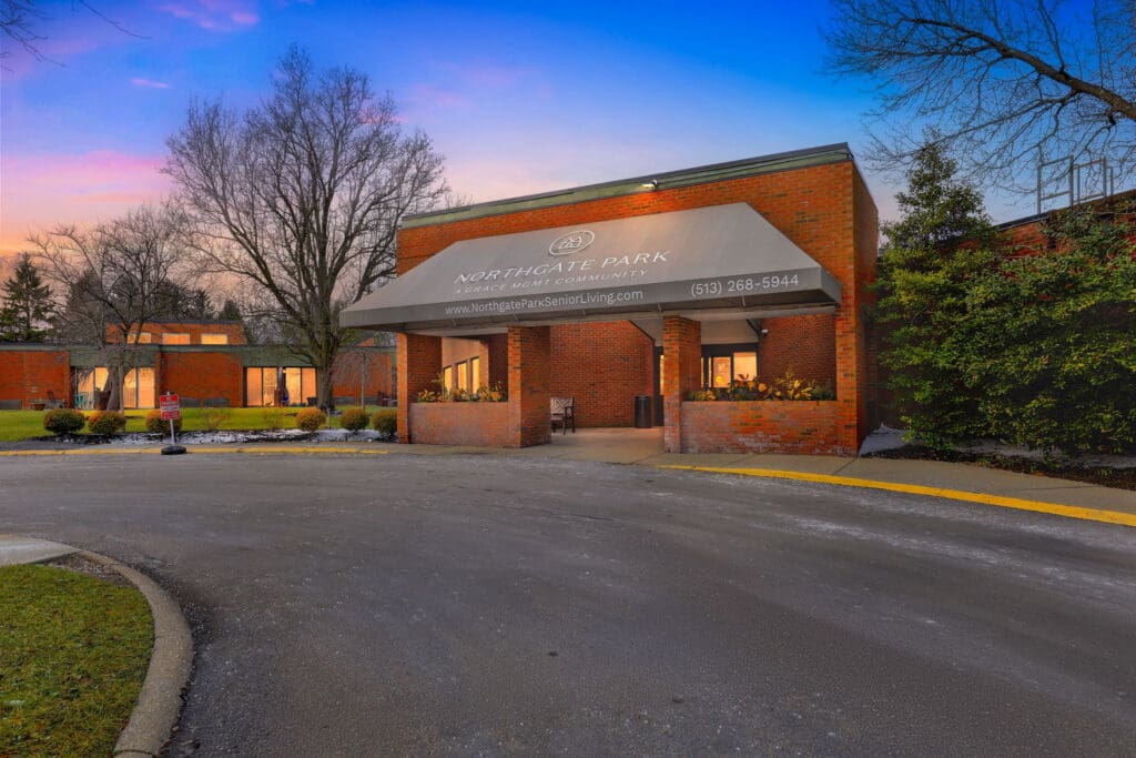 Exterior_NorthgatePark_Dusk - Grace Management Elegant entrance of Northgate Park with inviting landscaping, showcasing a warm, welcoming senior living community.