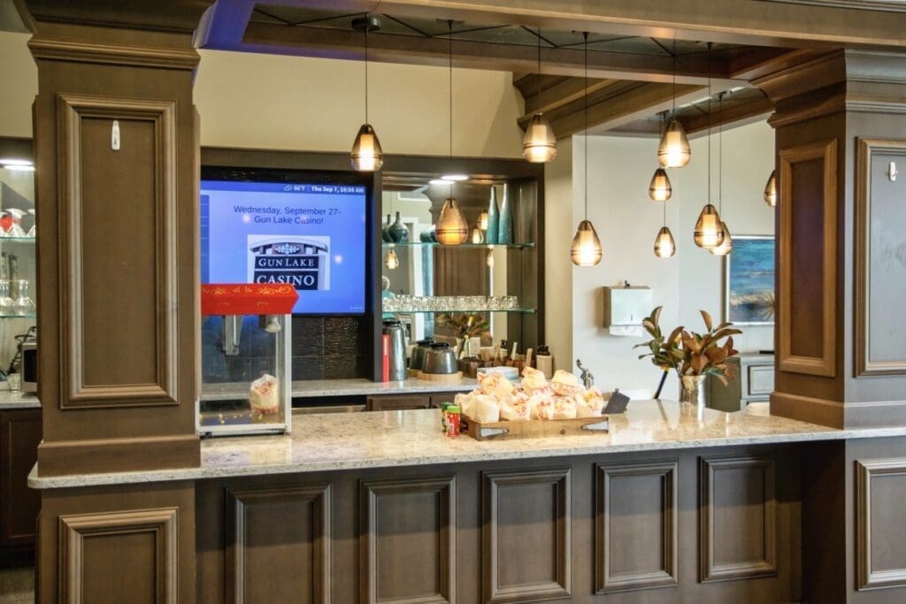 Food-Snacks-02-Large - Grace Management Contemporary café counter featuring popcorn machine, elegant lighting, and a promotional sign for Gun Lake Casino.