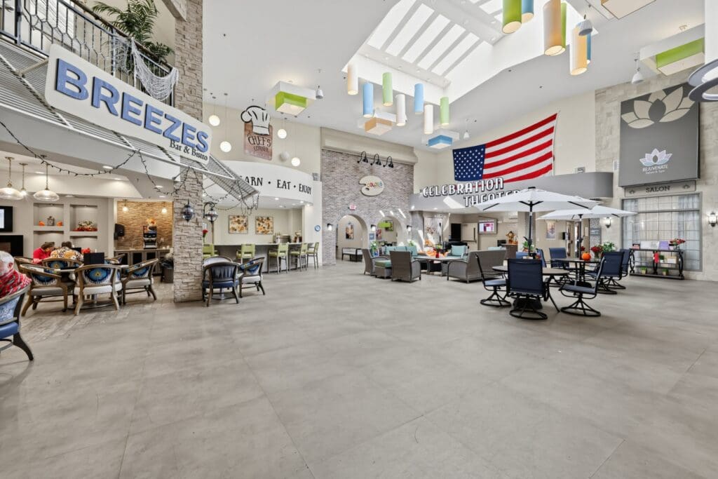Vibrant common area with comfortable seating, a bar, and a welcoming atmosphere, featuring colorful decor and an American flag.