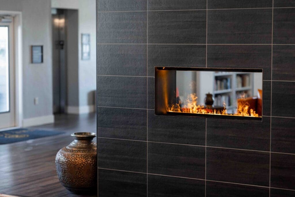 Sleek interior featuring a modern fireplace surrounded by elegant decor, creating a warm and inviting atmosphere.