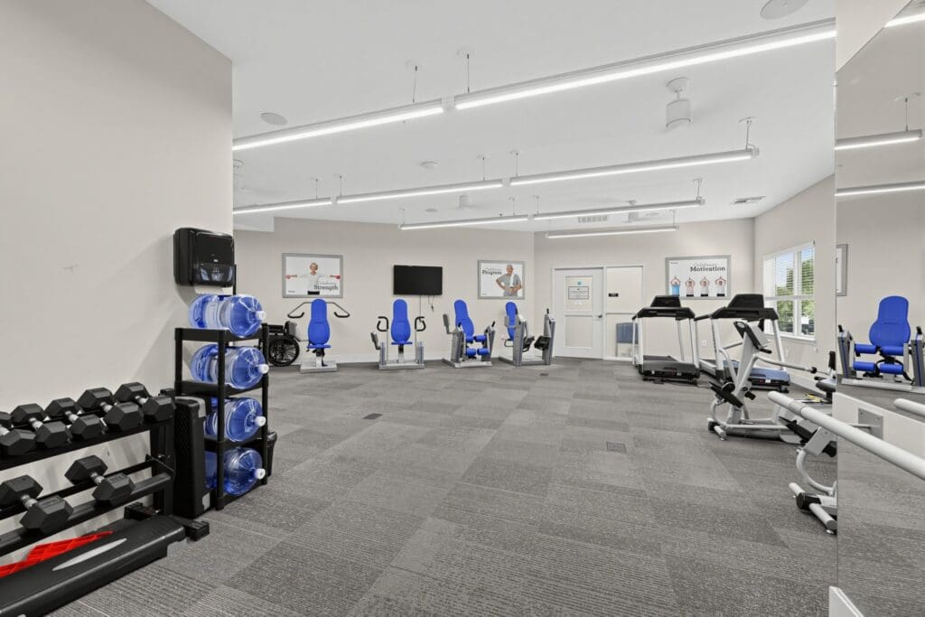 Bright fitness center featuring state-of-the-art equipment, including treadmills and strength machines, promoting an active lifestyle.
