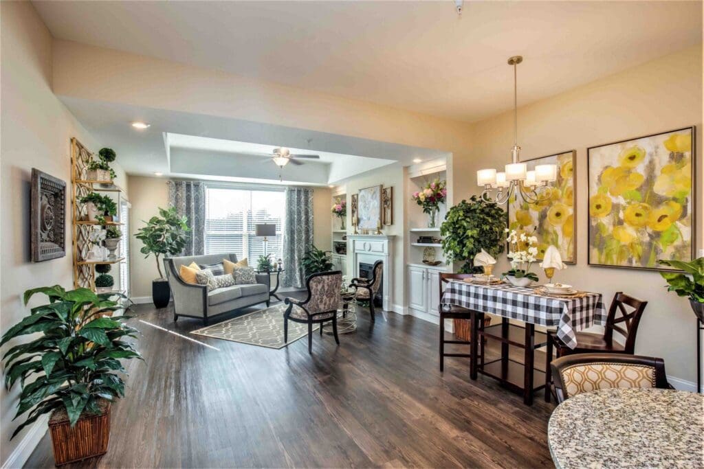 Elegant living area featuring stylish furniture, vibrant decor, and cheerful plants, promoting a warm, inviting atmosphere.