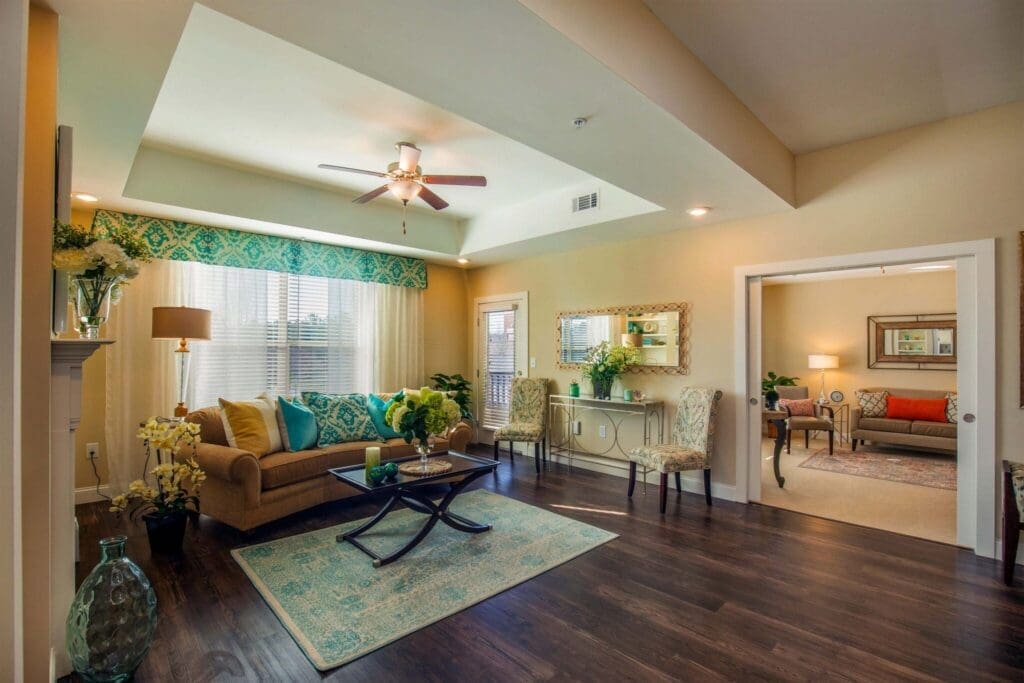 Stylish living room featuring cozy seating, vibrant decor, and natural light, reflecting an upscale, inviting atmosphere.