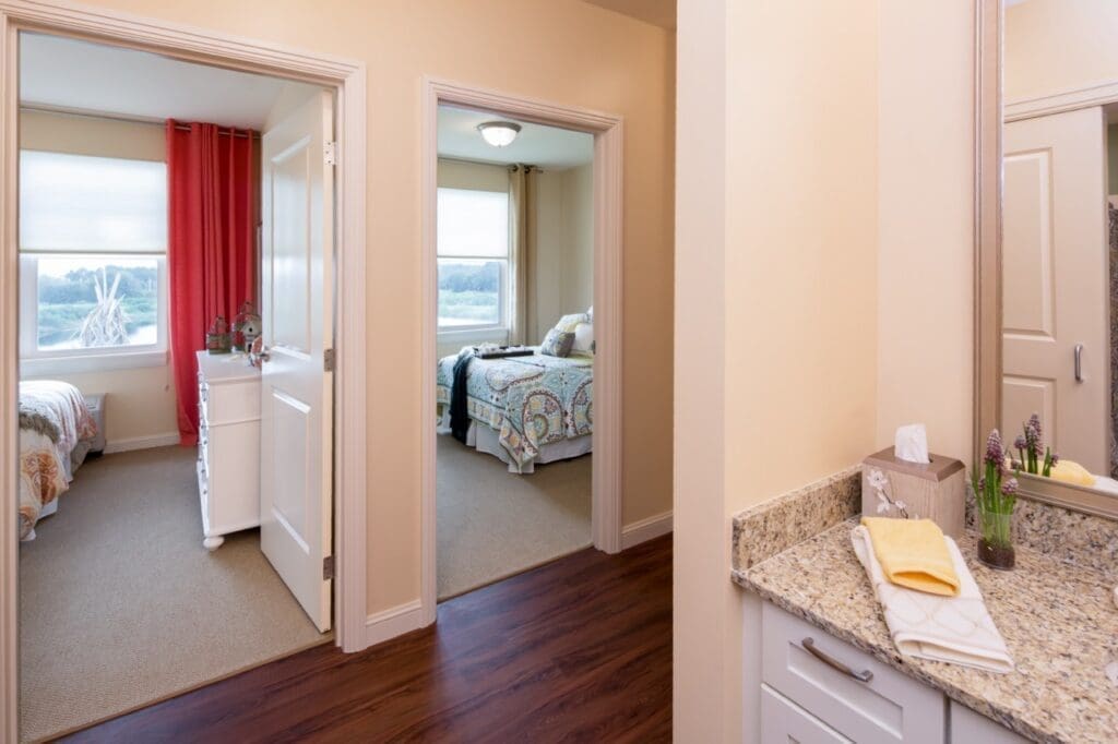 Brightly lit, welcoming room layout with two bedrooms, stylish furnishings, and a modern bathroom, exuding comfort and elegance.