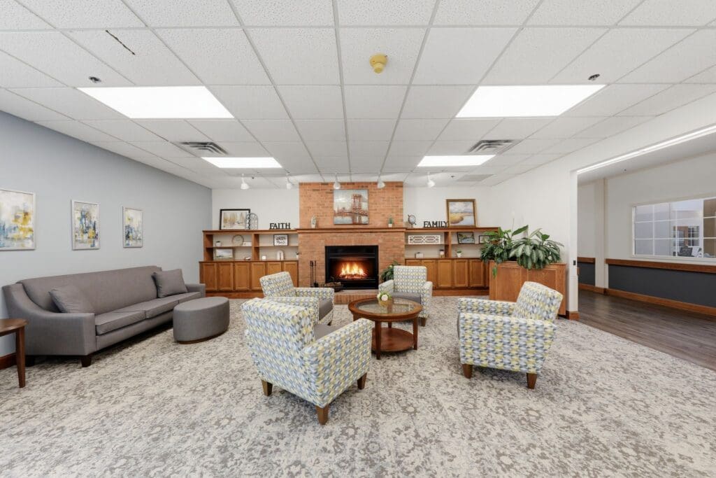 LivingRoom_NorthgatePark - Grace Management Inviting lounge area featuring a cozy fireplace, elegant seating, and tasteful decor, promoting a vibrant community atmosphere.