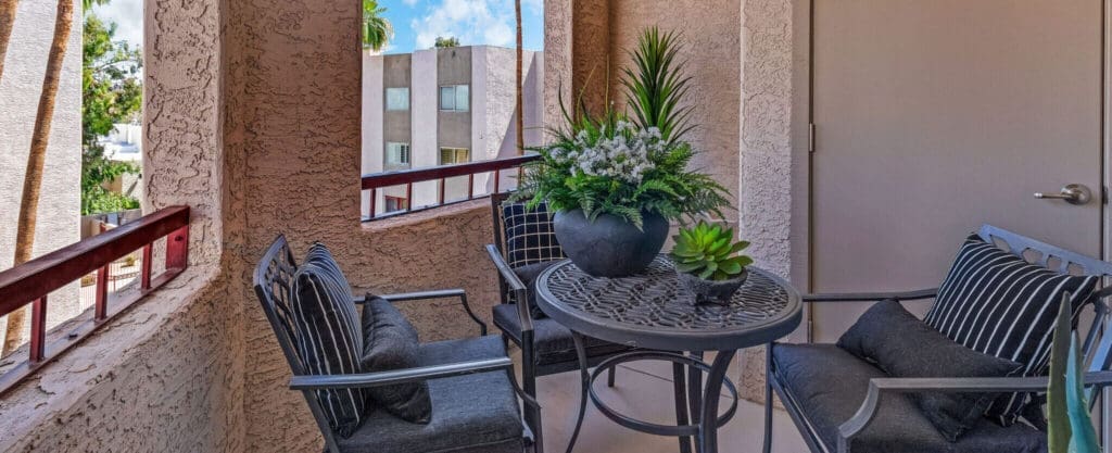 MG_4428-e1687984606797 - Grace Management Inviting balcony with stylish seating and lush greenery, offering a serene outdoor space for relaxation.