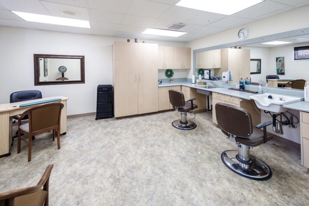 Bright, inviting salon space featuring styling chairs, a mirrored countertop, and elegant cabinetry for a vibrant lifestyle.