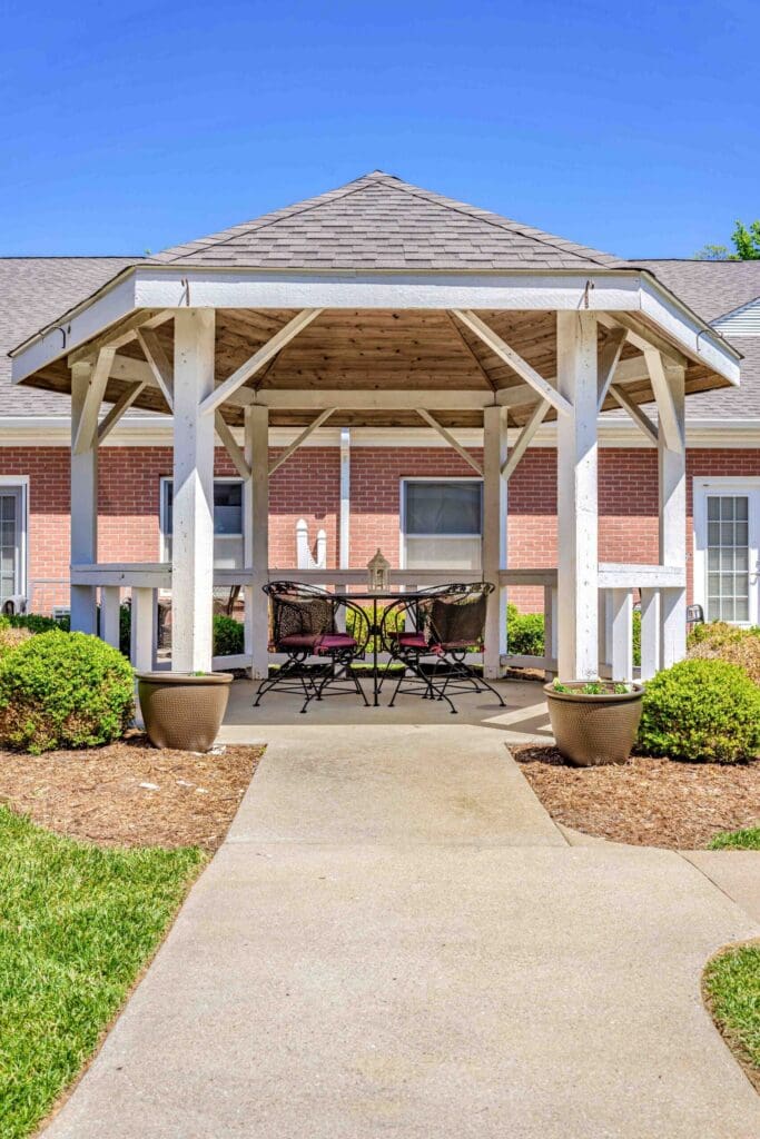 Charming gazebo with seating, surrounded by lush greenery and pathways, inviting a vibrant outdoor lifestyle.