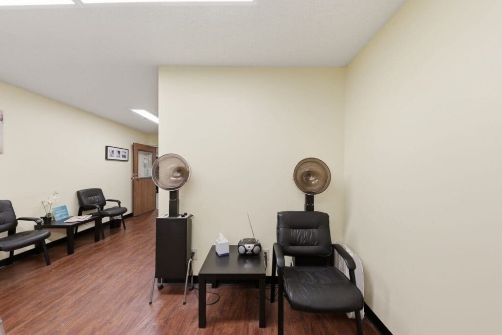 Salon_NorthgatePark - Grace Management Welcoming salon area featuring sleek black chairs, stylish hairdryers, and a calming ambiance for a vibrant, upscale experience.