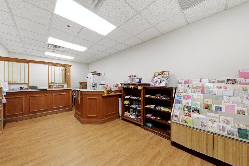 Shop_NorthgatePark - Grace Management Welcoming reception area with wooden countertops, vibrant greeting cards, and a display of gifts and magazines.