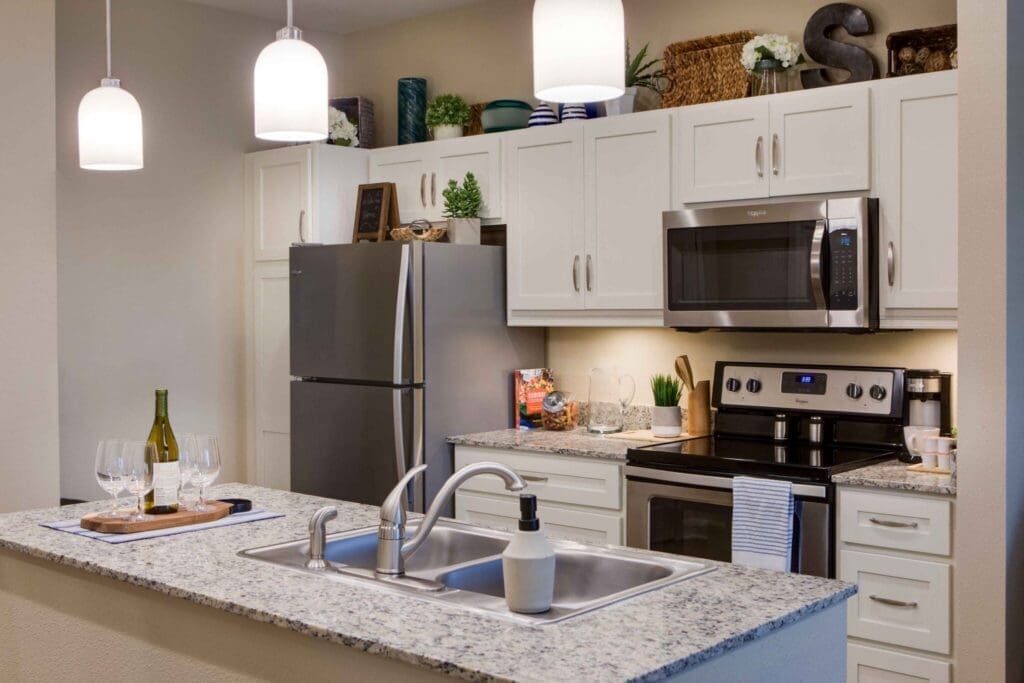 Modern, beautifully designed kitchen featuring upscale appliances, vibrant decor, and elegant dining setup with wine glasses.