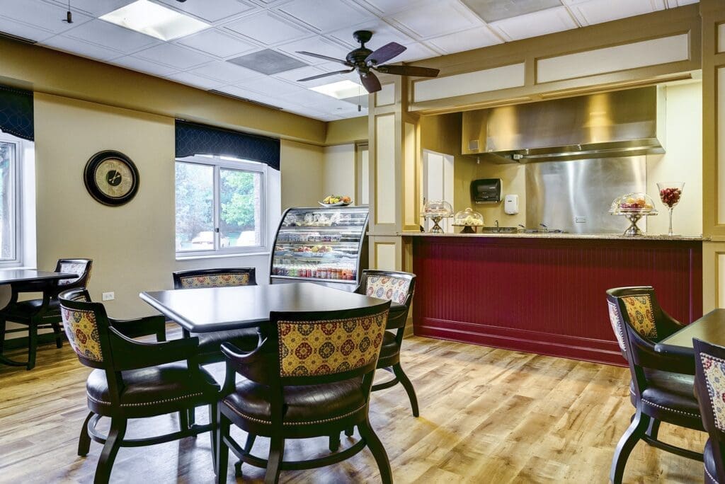 Inviting dining area with elegant furniture, warm lighting, and a display of fresh fruit and refreshments.