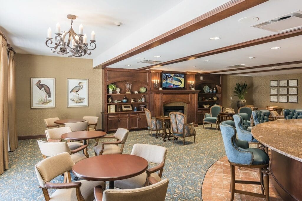 clubroom-2-Large - Grace Management Elegant common area featuring plush seating, warm lighting, and tasteful decor, inviting a vibrant community atmosphere.