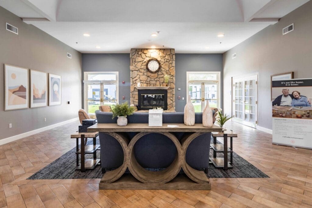 Welcoming lobby featuring stylish seating, a stone fireplace, and vibrant decor, fostering a community-oriented atmosphere.
