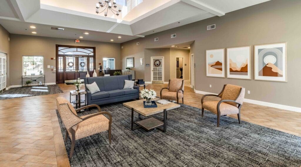Welcoming lounge area with modern furnishings, vibrant artwork, and natural light, promoting a warm and inviting atmosphere.