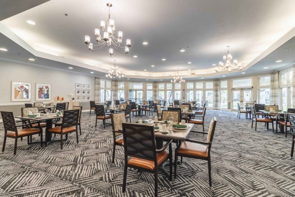 Elegant dining area featuring stylish tables, comfortable seating, and large windows, creating a warm, inviting atmosphere.
