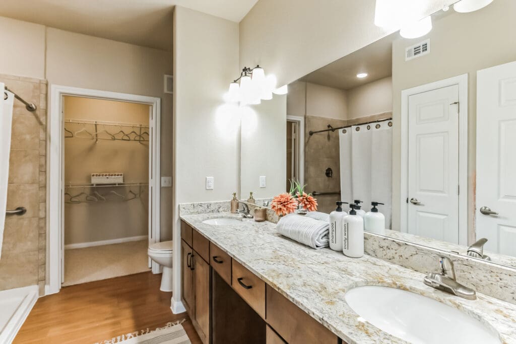 Interior image of a resident's apartment, showing a spacious bathroom and walk-in closet at Woodhaven Village, a senior living community near The Woodlands, TX.
