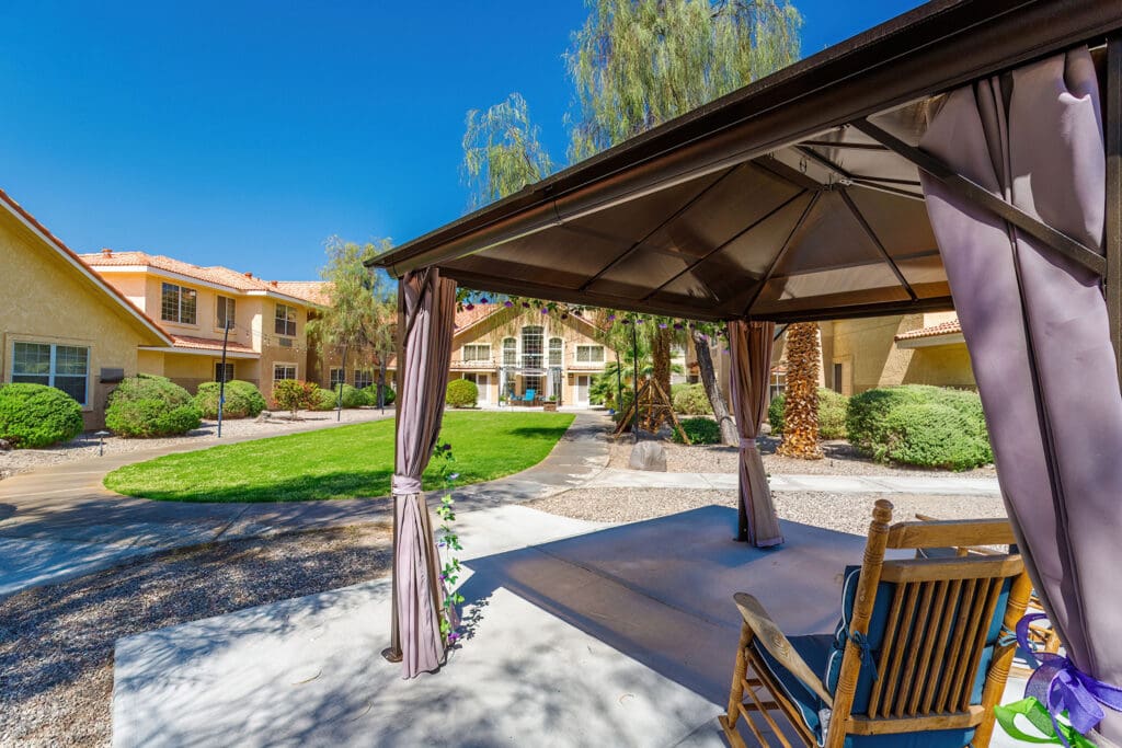 - Grace Management Exterior image a patio with covered seating and greenery at Vista Pointe at Lake Havasu City, a senior living community near Bullhead City.