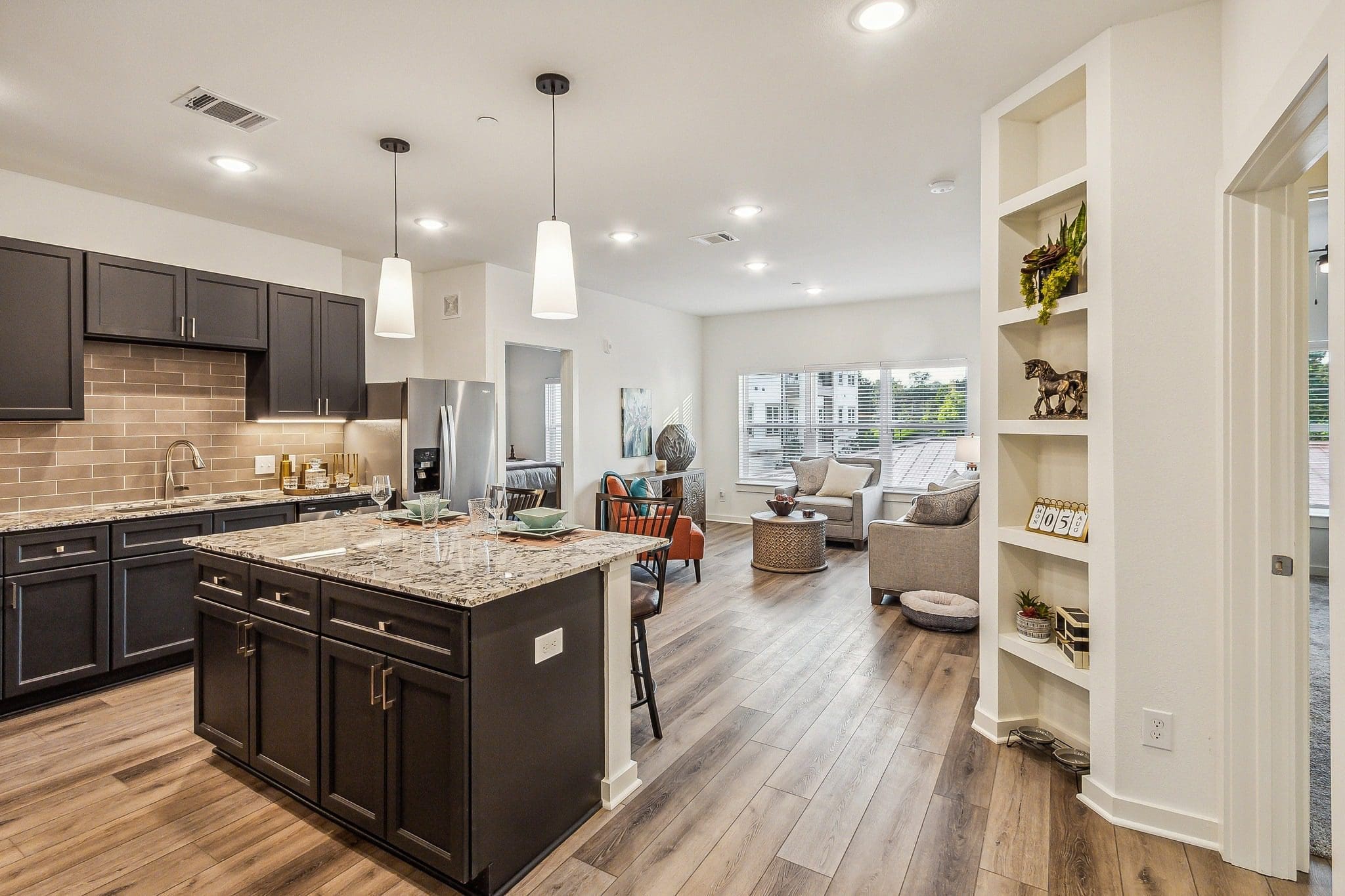 Interior private resident's kitchen and living room at The Lakes at Woodhaven Village, a retirement community near Huntsville, TX.