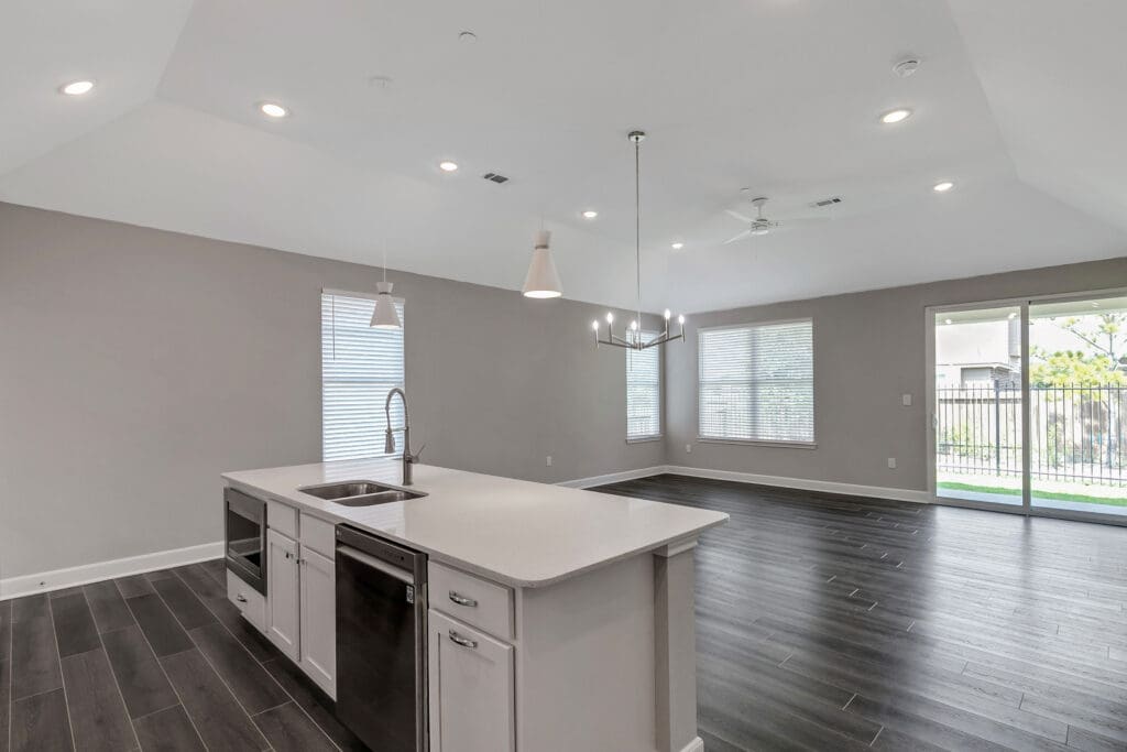 - Grace Management Interior image of a resident's kitchen and living space at Woodhaven Village, a senior living community near Spring, TX.