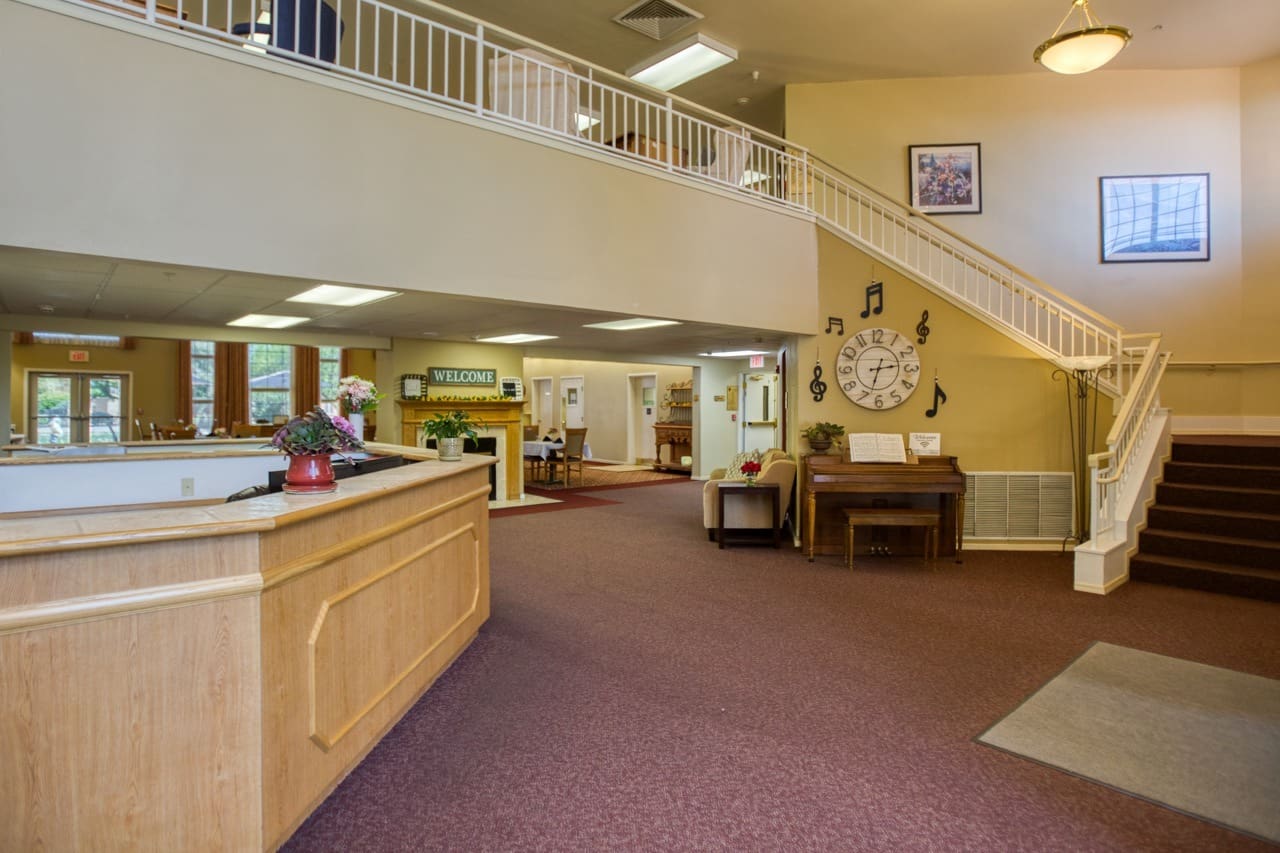 Interior image of Vista Pointe at Sierra Vista's lobby and entry way, showing a large staircase leading to a balcony upstairs.
