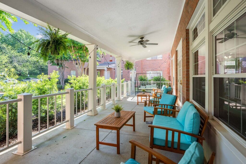 - Grace Management Spacious covered terrace overlooking gardens at Town Village Audubon Park, an ideal senior living community.