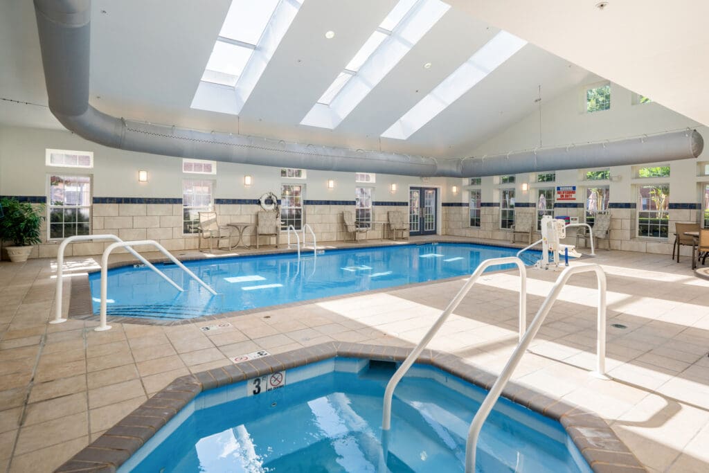 - Grace Management Indoor swimming pool and hot tub at Town Village Audubon Park, a luxurious senior living option.