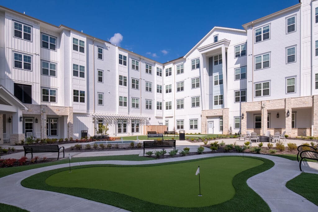 - Grace Management Scenic courtyard with lush greenery and a putting green at The Summit of Germantown, offering independent and assisted living in Cordova.