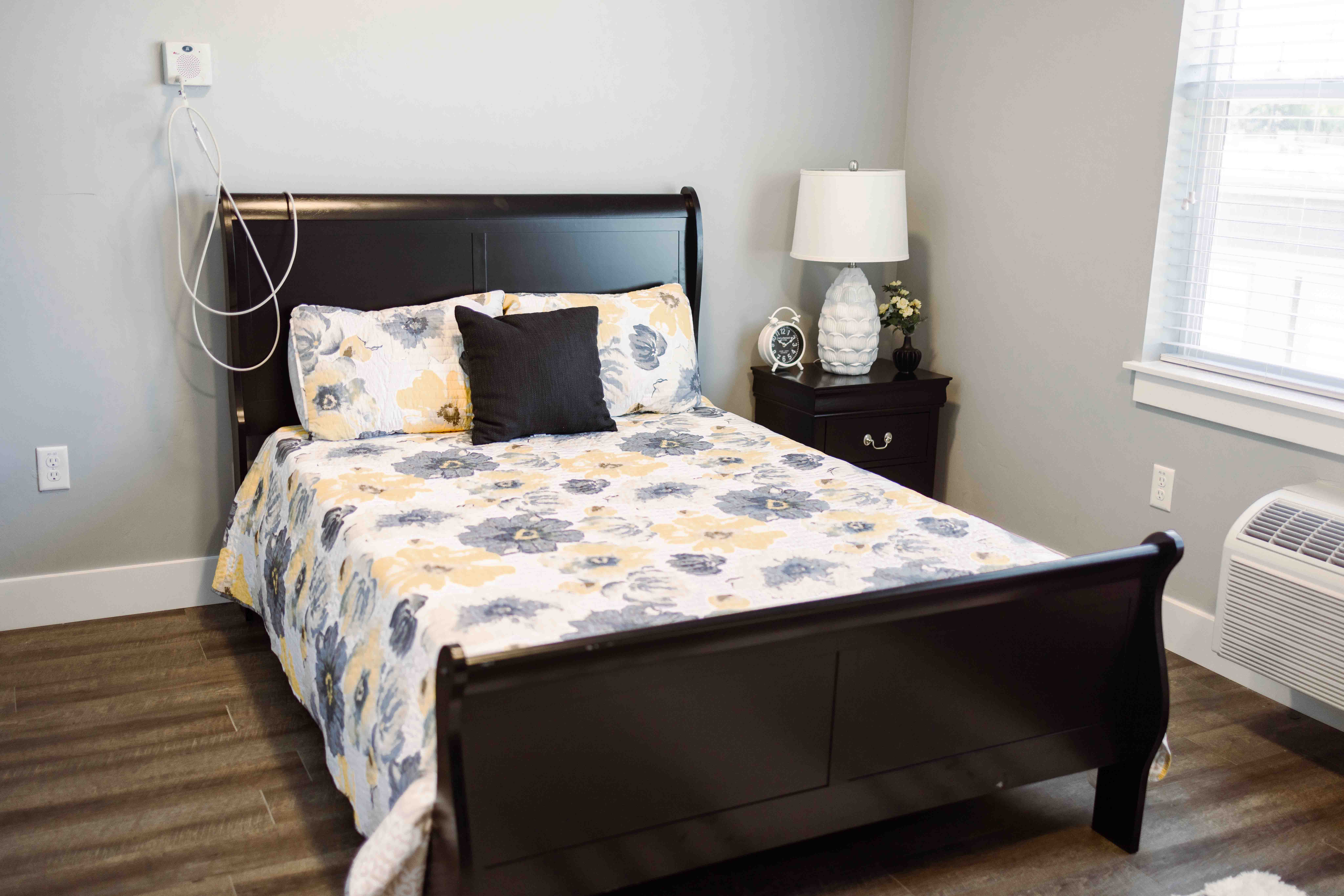 - Grace Management Interior image of a resident's apartment bedroom at The Pointe at Meridian.