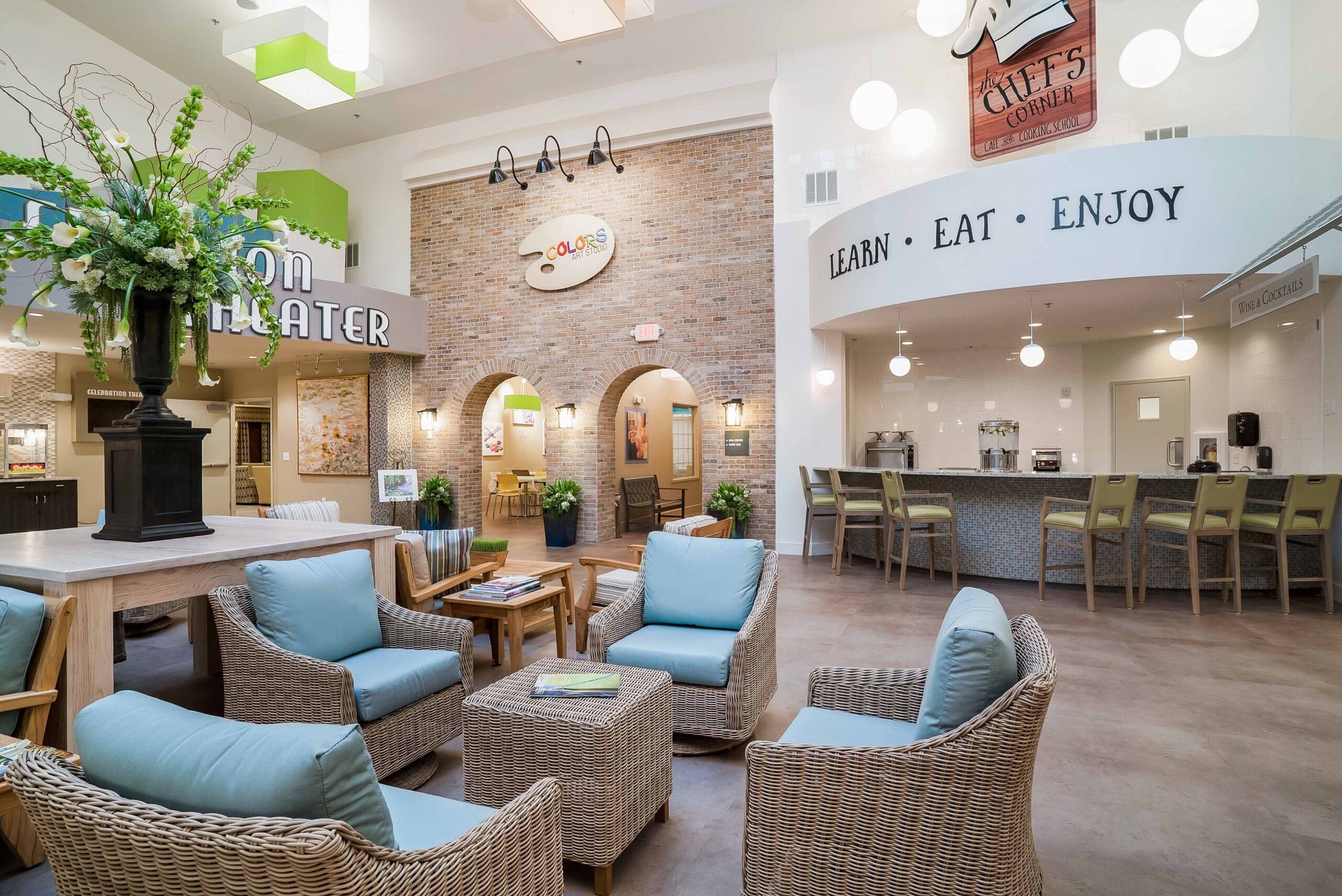 - Grace Management A photo of the indoor sitting room with the Chef's Corner bar, Colors arts studio, and a movie theater at Celebration Village Forsyth, a senior living community near Alpharetta, GA.