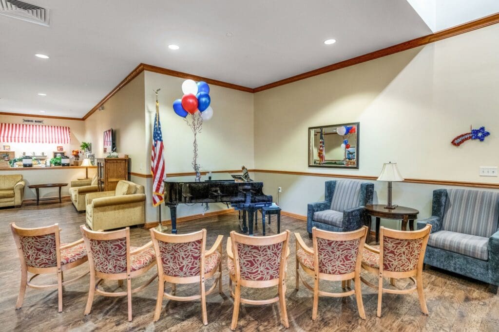- Grace Management Chairs are arranged for a performance in front of a piano in the lounge at Town Village Sterling Heights, a senior living community near Detroit.