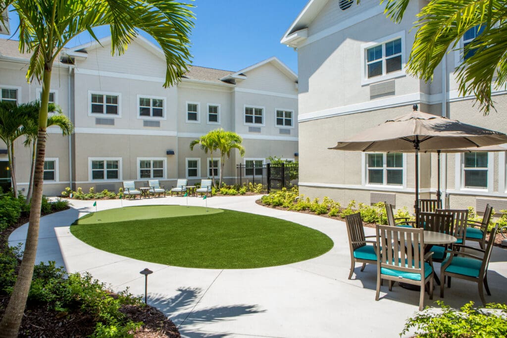 - Grace Management A putting green is the centerpiece of the landscaped courtyard at Heritage Oaks of Englewood, a senior living community near Venice, FL.