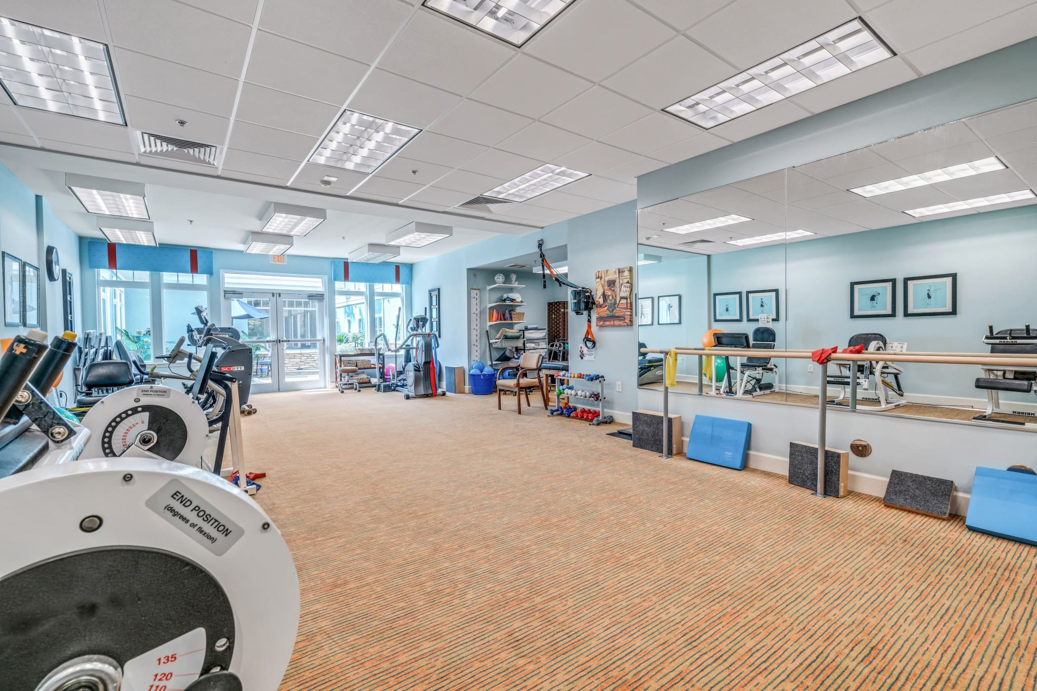 Interior image of a well stocked gym center at Camellia at Deerwood, senior living community near Ponte Vedra.
