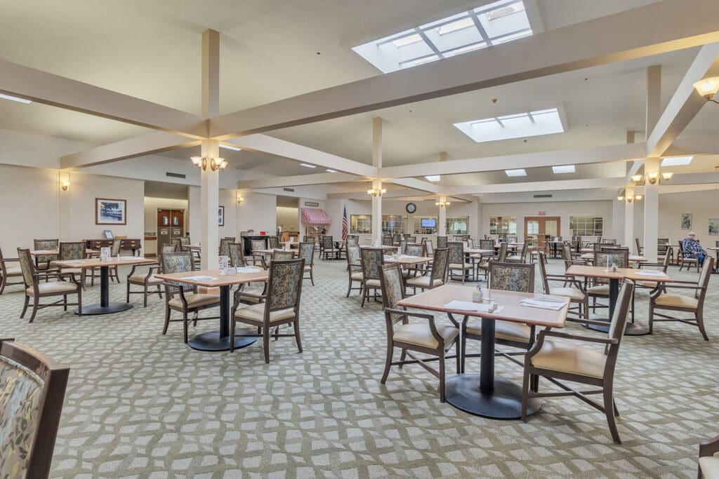 - Grace Management A dining room with brown chairs and tables at Northgate Park.