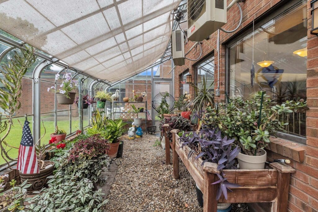 - Grace Management A covered garden with a variety of potted plants and an American flag in the left corner at Northgate Park.