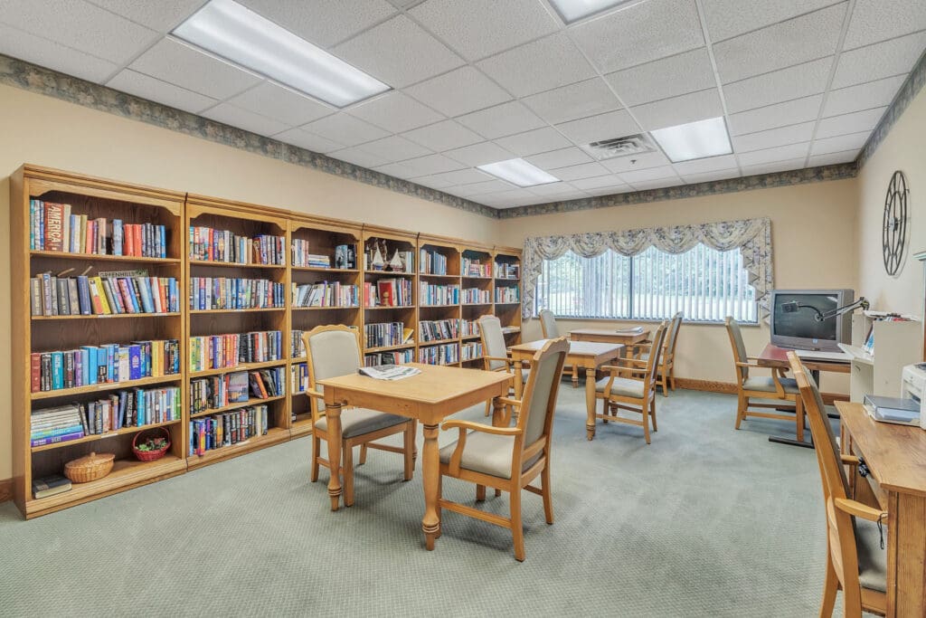 - Grace Management An on-site library with bookshelves and reading tables at Northgate Park, a senior living community.