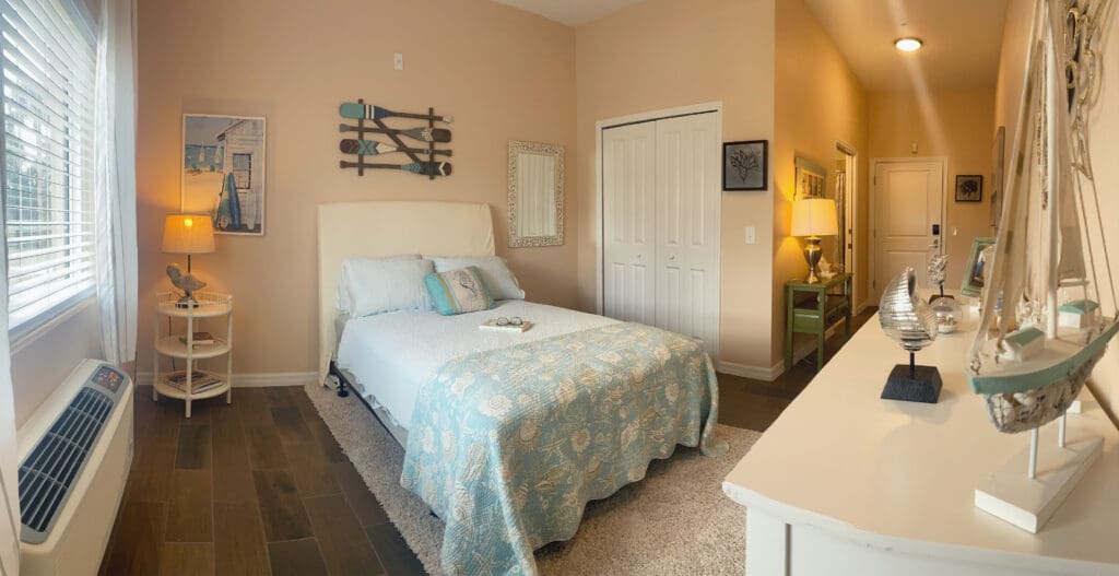 - Grace Management Interior bedroom at Palm Bay Memory Care, a community offering senior living.