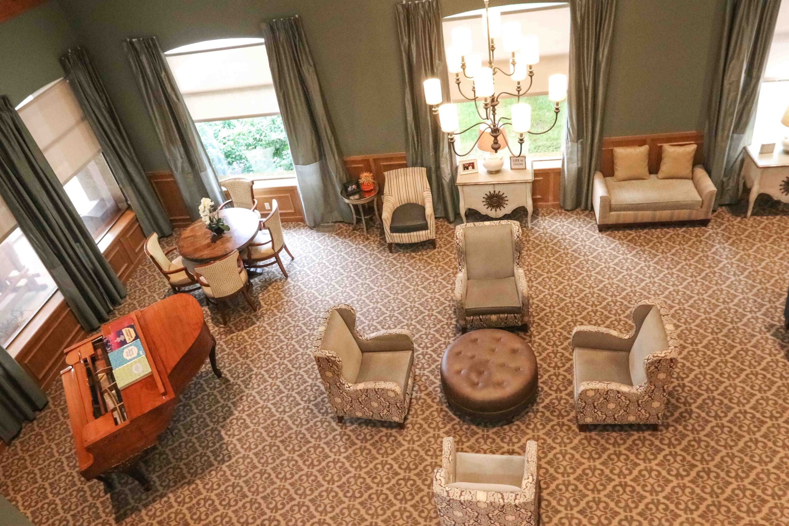 - Grace Management Interior aerial image of the common room with plenty of comfortable seating and a baby grand piano at Sedgwick Plaza.
