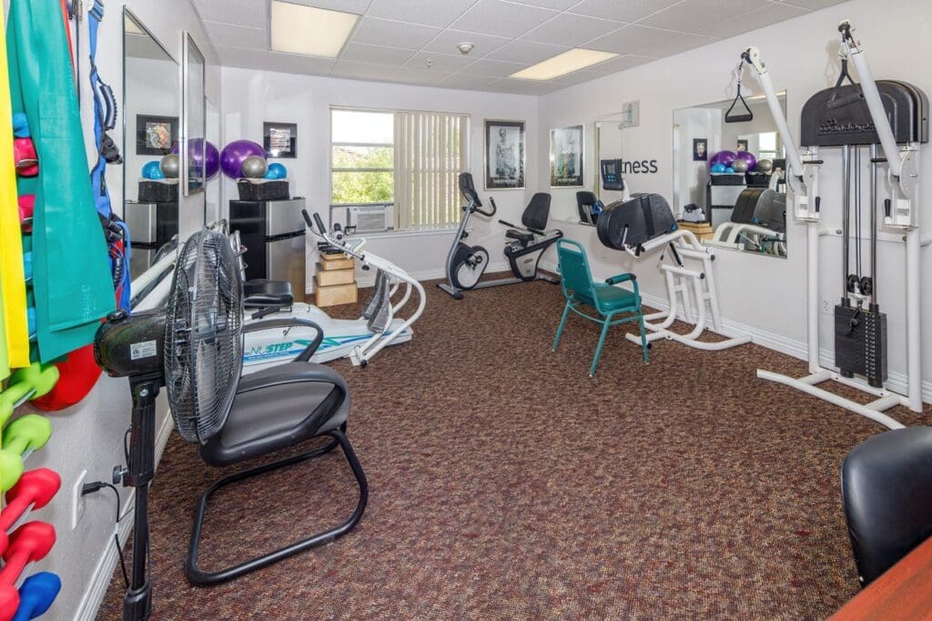 - Grace Management Weight room with various exercise machines at Vista Pointe at Mira Loma.