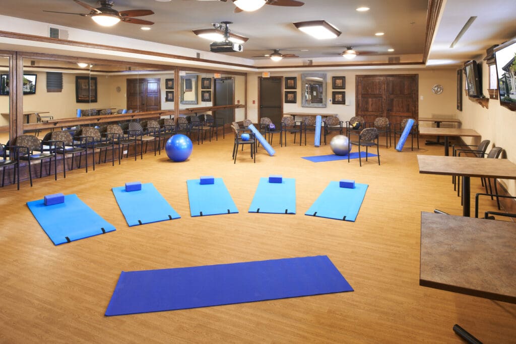 - Grace Management Interior image of a gym space set up for a yoga class at The Landon at Lake Highlands, a senior living community in Lakewood, TX.