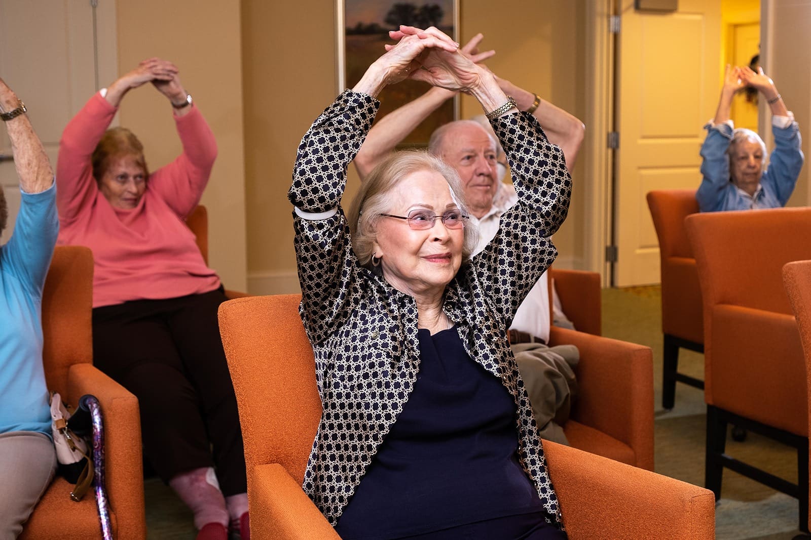 Residents engaging in a group exercise class at The Summit of Lakewood Ranch, a senior living community.