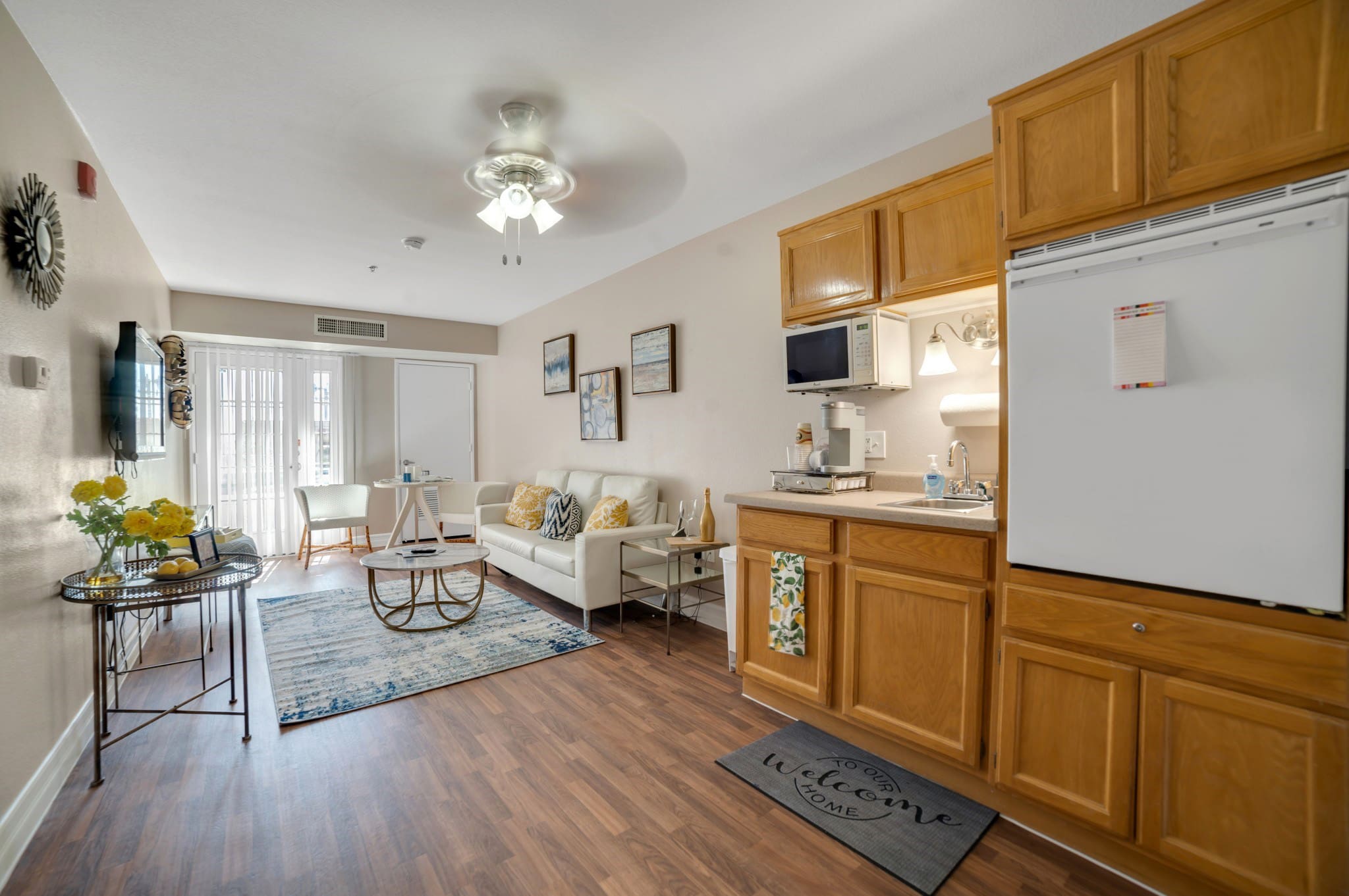 Interior apartment with a kitchenette and living room at Acacia Springs, a senior living community