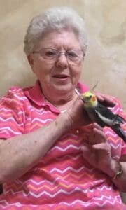 Happy senior woman with her adult daughter at home - Grace Management Heartwarming moment between two smiling women, one older, sharing companionship and joy in a bright, inviting setting.