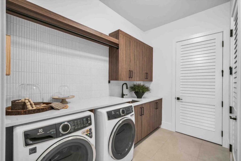 Elegant laundry room featuring modern appliances, sleek cabinetry, and decorative elements for a vibrant lifestyle.