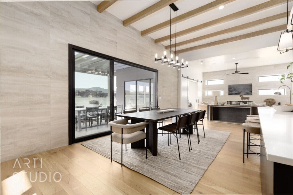 Elegant dining area with modern furnishings, large windows showcasing scenic views, and an open layout promoting social gatherings.