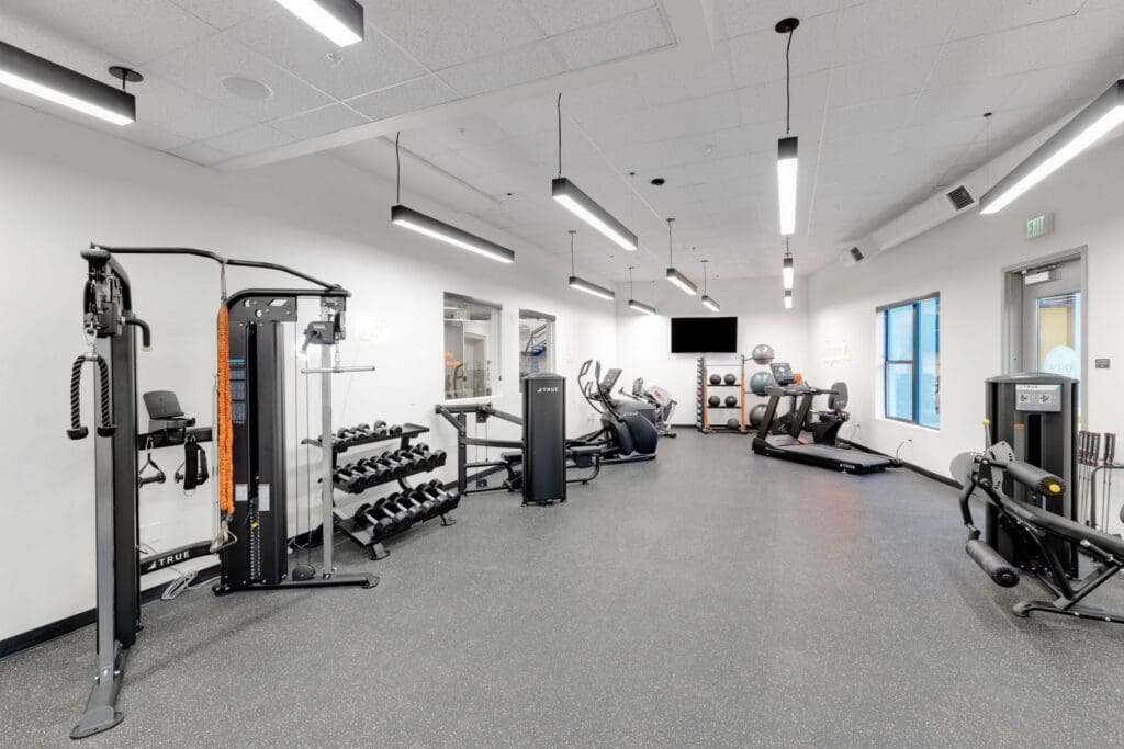 Bright and modern fitness center featuring advanced equipment and a spacious layout for an active, vibrant lifestyle.