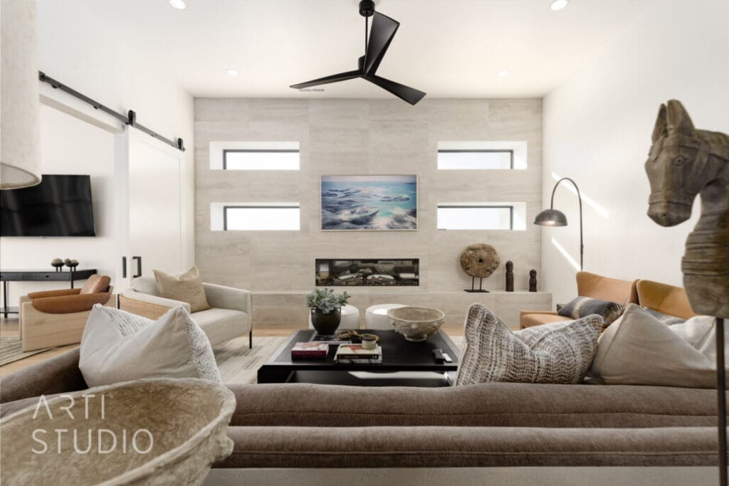 Elegant living room featuring modern furnishings, a cozy fireplace, and tasteful art, promoting a vibrant, upscale lifestyle.