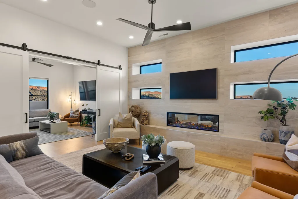 Elegant living space featuring modern furnishings, a cozy fireplace, and scenic views through large windows.