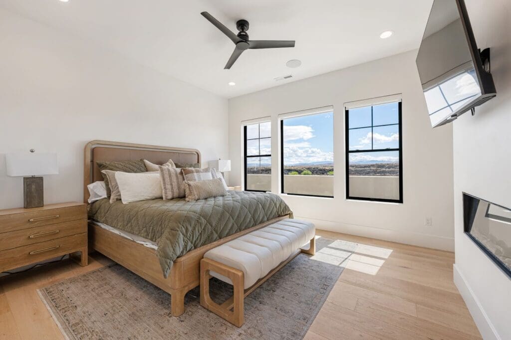 Elegant bedroom featuring a cozy bed, ample natural light, and upscale furnishings, promoting a serene, vibrant lifestyle.